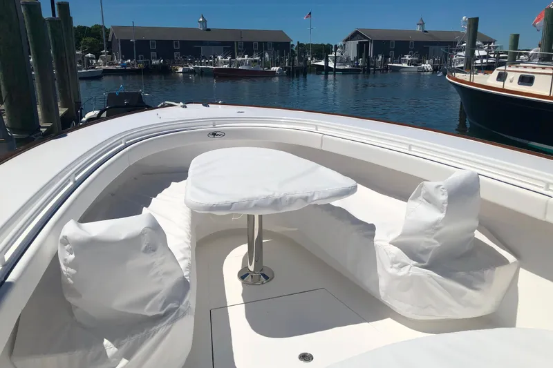 Slide: The Image of 2025 Valhalla Boatworks V-41 with covered seating and table, docked at a marina. - 17