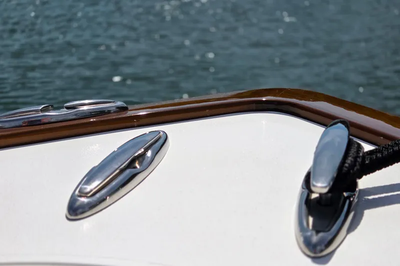 Slide: The Image of 2025 Valhalla Boatworks V-41 deck with chrome fittings and water backdrop. - 24
