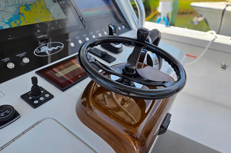 Slide: The Image of 2025 Valhalla Boatworks V-41 helm with advanced navigation controls and sleek steering wheel. - 8