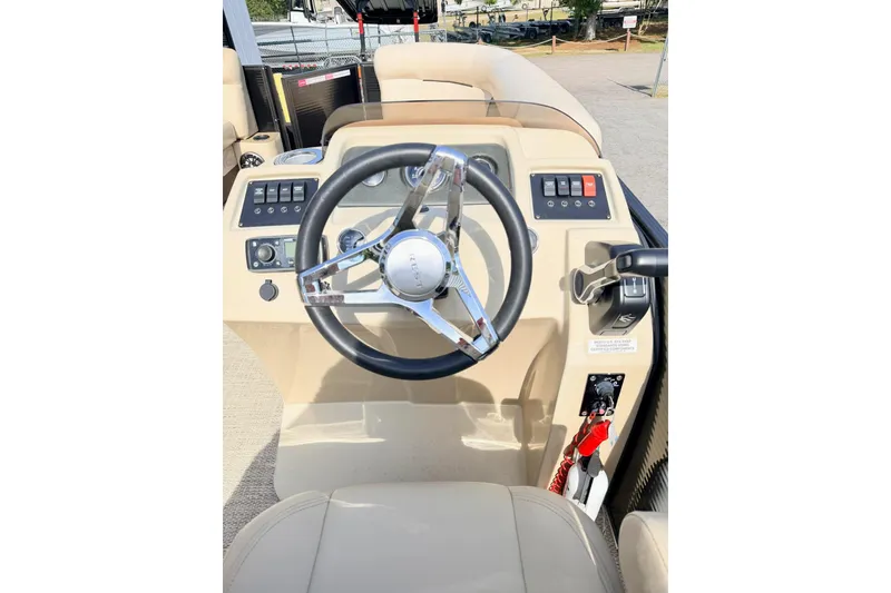 Slide: The Image of Steering console of 2021 Crest Classic DLX 220 SLC boat with controls and switches. - 14