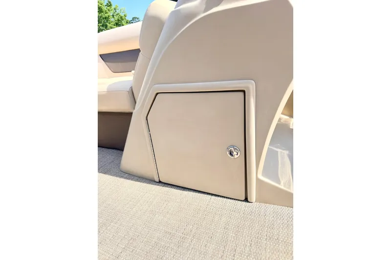 Slide: The Image of 2021 Crest Classic DLX 220 SLC boat interior storage compartment with beige finish. - 15