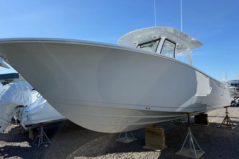 The Image of 2026 Sportsman Open 302 Center Console boat on display, elevated on stands. - 0