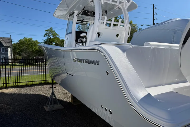 Slide: The Image of 2026 Sportsman Open 302 Center Console boat displayed outdoors. - 1