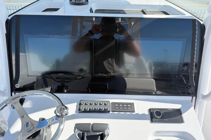 Slide: The Image of 2026 Sportsman Open 302 Center Console dashboard with Garmin displays and steering wheel. - 10
