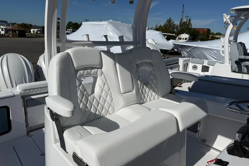 Slide: The Image of 2026 Sportsman Open 302 Center Console boat with luxurious seating and modern design. - 12
