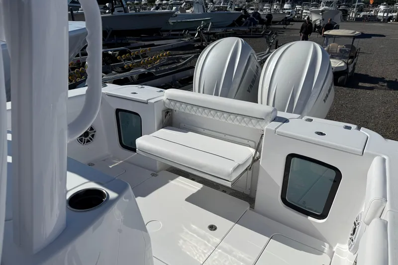Slide: The Image of 2026 Sportsman Open 302 Center Console boat with dual engines and seating area. - 14
