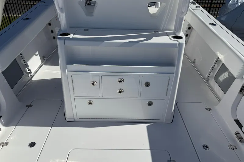 Slide: The Image of 2026 Sportsman Open 302 Center Console boat interior with storage compartments. - 16