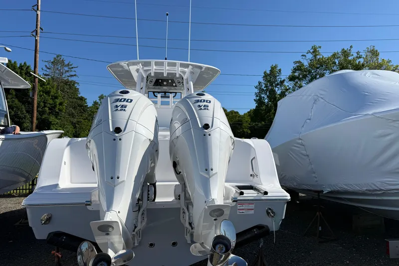 Slide: The Image of 2026 Sportsman Open 302 Center Console with dual 300 V6 outboard engines. - 2
