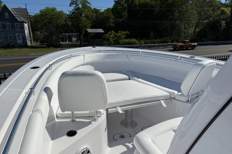 Slide: The Image of 2026 Sportsman Open 302 Center Console boat with white seating and table. - 3