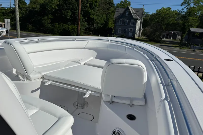 Slide: The Image of 2026 Sportsman Open 302 Center Console boat with white seating and table. - 4