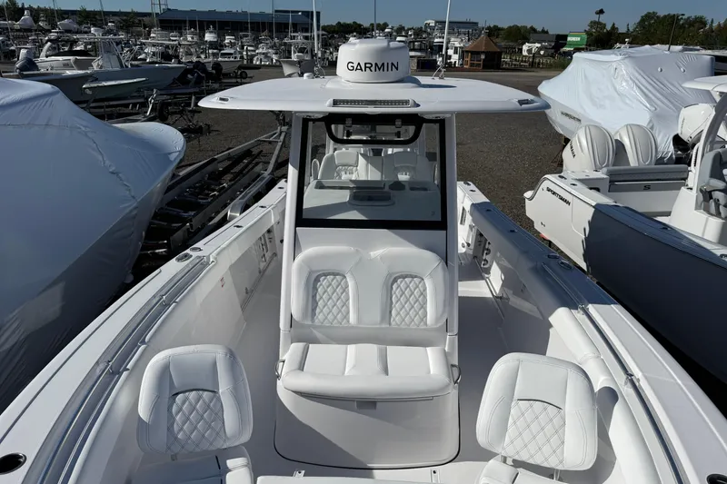 Slide: The Image of 2026 Sportsman Open 302 Center Console boat with white seating and Garmin equipment. - 5