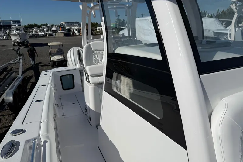 Slide: The Image of 2026 Sportsman Open 302 Center Console boat, sleek design, docked at marina. - 7