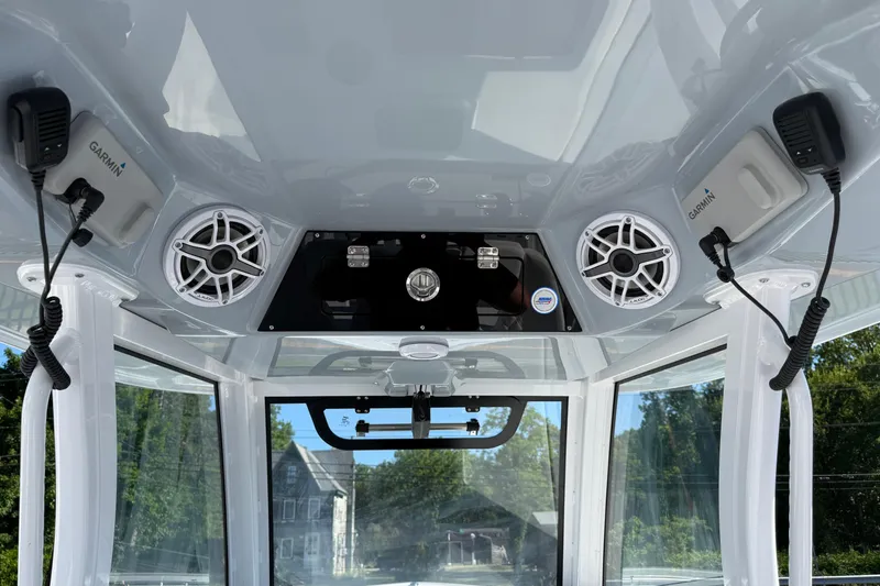 Slide: The Image of 2026 Sportsman Open 302 Center Console interior with Garmin electronics and speakers. - 9