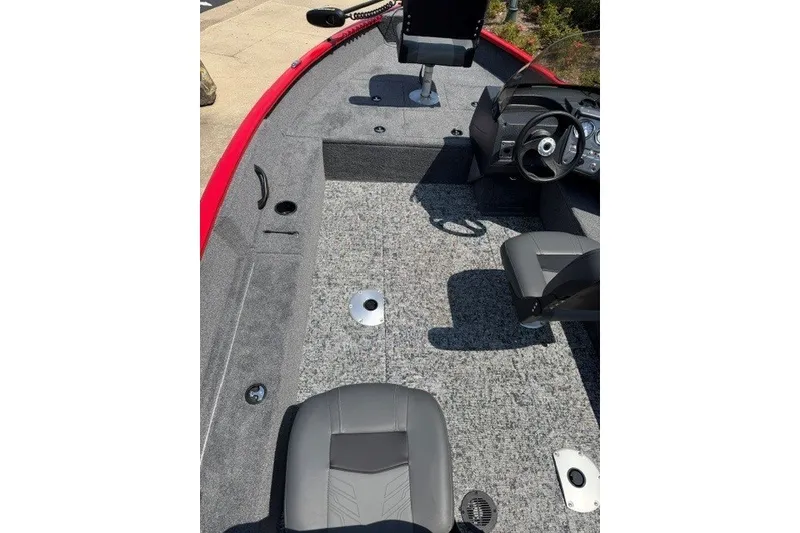 Slide: The Image of 2026 Tracker Pro Guide V-16 SC boat interior with gray seating and steering console. - 12