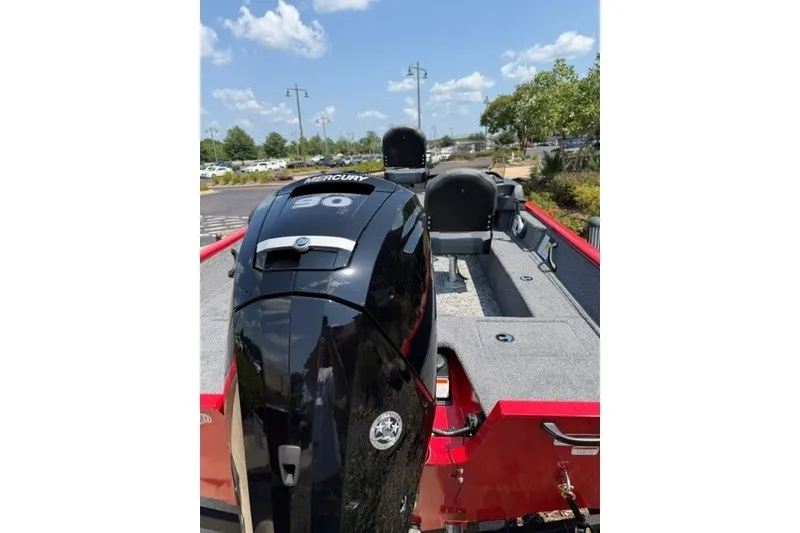 Slide: The Image of 2026 Tracker Pro Guide V-16 SC boat with Mercury 90 engine, parked outdoors. - 4