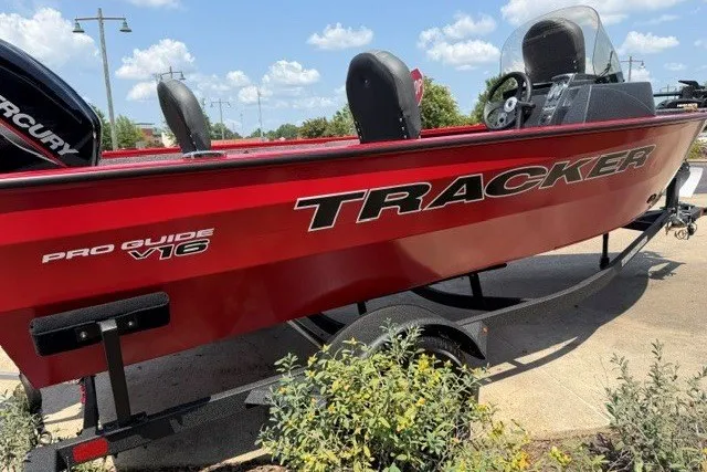Slide: The Image of Red 2026 Tracker Pro Guide V-16 SC boat on trailer, sunny day, clear sky. - 3