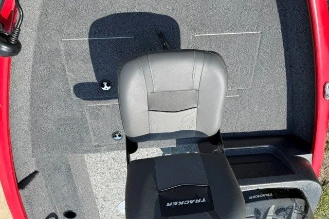 Slide: The Image of 2026 Tracker Pro Guide V-16 SC boat interior with gray seating and red accents. - 11