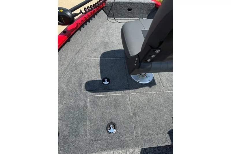 Slide: The Image of 2026 Tracker Pro Guide V-16 SC boat interior with gray carpet and seating. - 10