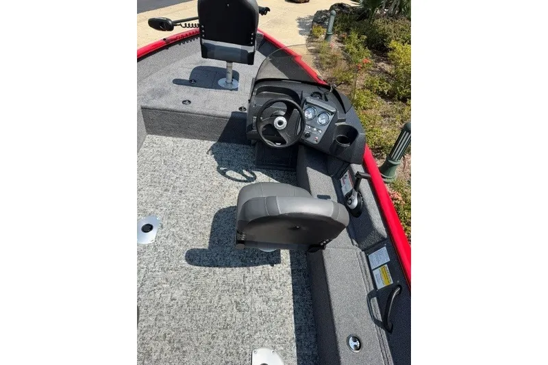 Slide: The Image of 2026 Tracker Pro Guide V-16 SC boat interior with steering wheel and seating. - 9