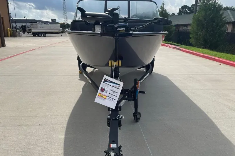 Slide: The Image of 2026 Tracker Pro Guide V-16 WT boat on trailer in outdoor setting. - 2