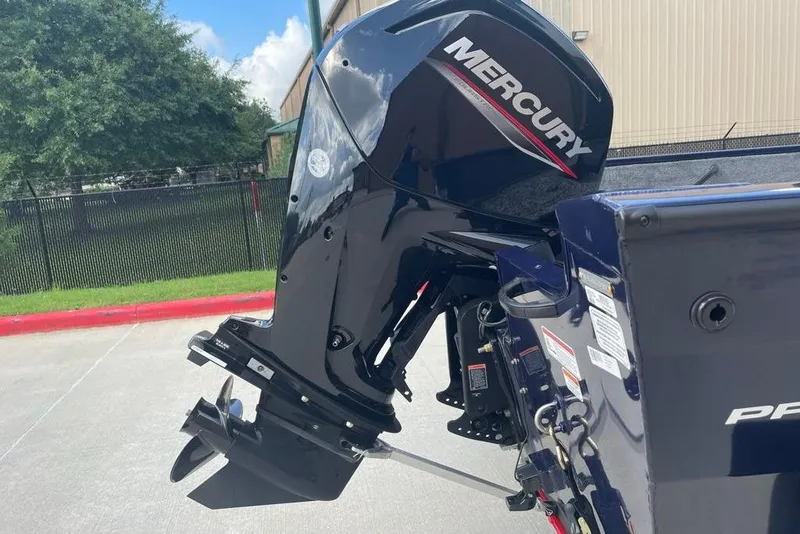Slide: The Image of 2026 Tracker Pro Guide V-16 WT boat with Mercury outboard motor in a sunny outdoor setting. - 4