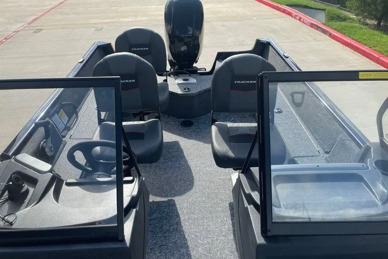 Slide: The Image of 2026 Tracker Pro Guide V-16 WT boat interior with seating and steering console. - 6