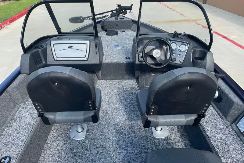 Slide: The Image of 2026 Tracker Pro Guide V-16 WT boat interior with dual seats and dashboard controls. - 7