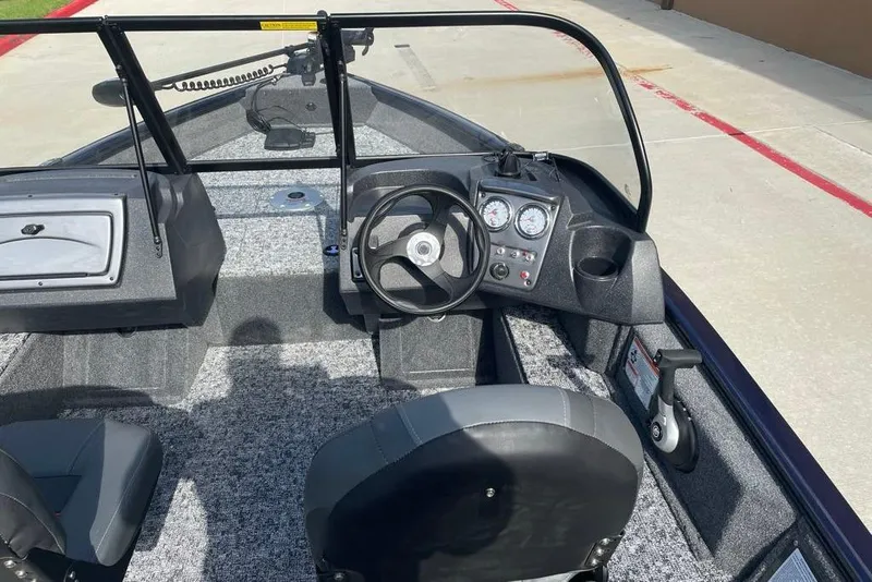 Slide: The Image of 2026 Tracker Pro Guide V-16 WT boat interior with steering wheel and dashboard controls. - 8