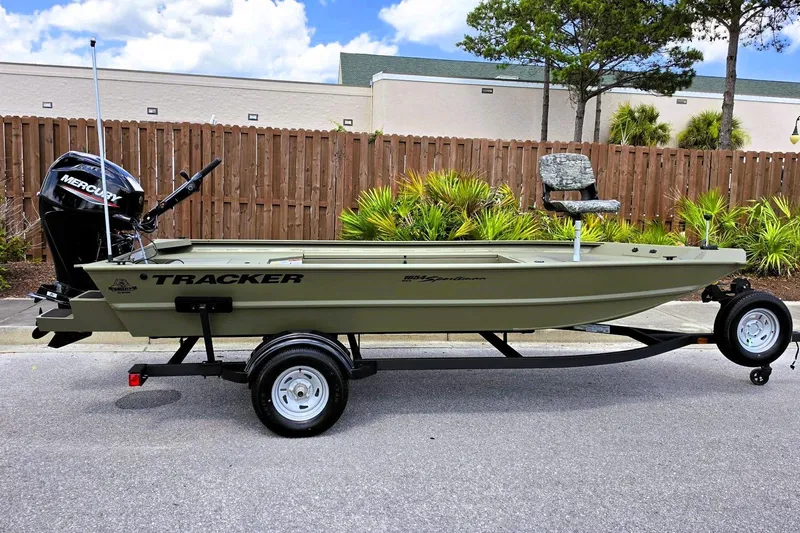 The Image of 2026 Tracker Grizzly 1654 T Sportsman boat on trailer, parked outdoors. - 0