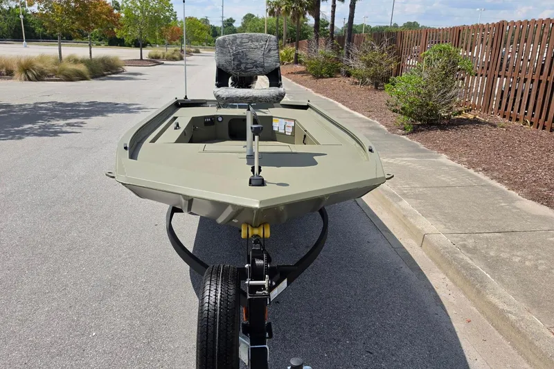 Slide: The Image of 2026 Tracker Grizzly 1654 T Sportsman boat on trailer, parked outdoors. - 7