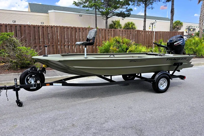 Slide: The Image of 2026 Tracker Grizzly 1654 T Sportsman boat on trailer, parked outdoors. - 9