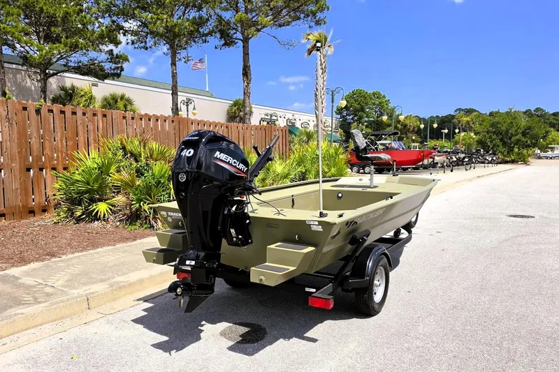 Slide: The Image of 2026 Tracker Grizzly 1654 T Sportsman boat with Mercury engine on trailer, outdoors. - 3