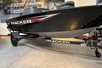 The Image of 2026 Tracker Pro Guide V-16 WT boat on trailer in showroom. - 0