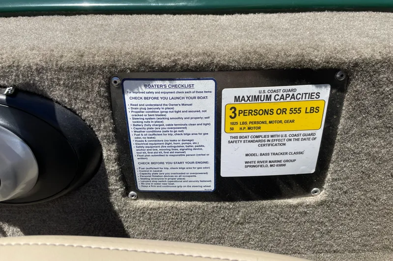 Slide: The Image of 2026 Tracker Bass Tracker Classic Limited capacity label, 3 persons or 555 lbs, safety checklist. - 12