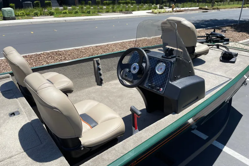 Slide: The Image of 2026 Tracker Bass Tracker Classic Limited boat interior with steering console and seating. - 3