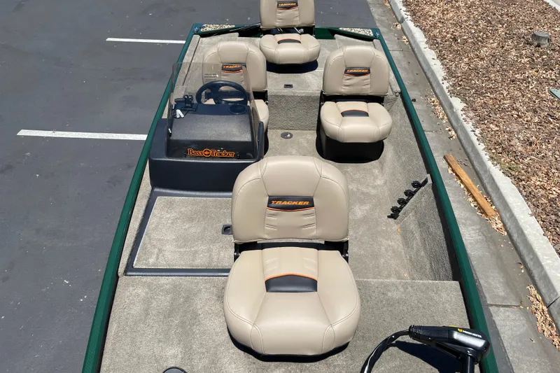 Slide: The Image of 2026 Tracker Bass Tracker Classic Limited boat with beige seating and steering console. - 9
