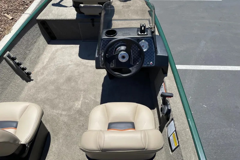 Slide: The Image of 2026 Tracker Bass Tracker Classic Limited boat interior with steering wheel and seats. - 4