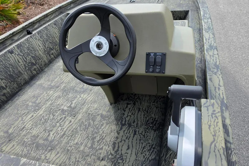 Slide: The Image of 2026 Tracker Grizzly 1648 SC boat steering console with camouflage design. - 11