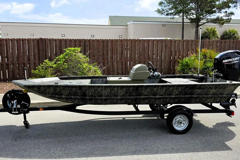 Slide: The Image of 2026 Tracker Grizzly 1648 SC boat on trailer, parked outdoors. - 6