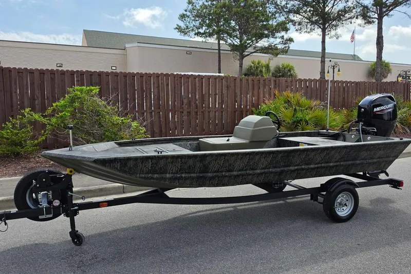 Slide: The Image of 2026 Tracker Grizzly 1648 SC boat on trailer, parked outdoors. - 7