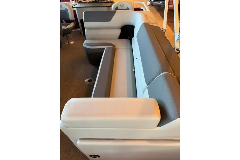 Slide: The Image of Interior seating of 2026 Sun Tracker Fishin' Barge 22 DLX, featuring comfortable gray and white upholstery. - 5