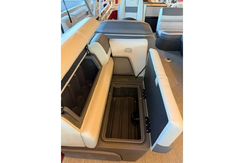 Slide: The Image of 2026 Sun Tracker Fishin' Barge 22 DLX interior with open storage compartments. - 9