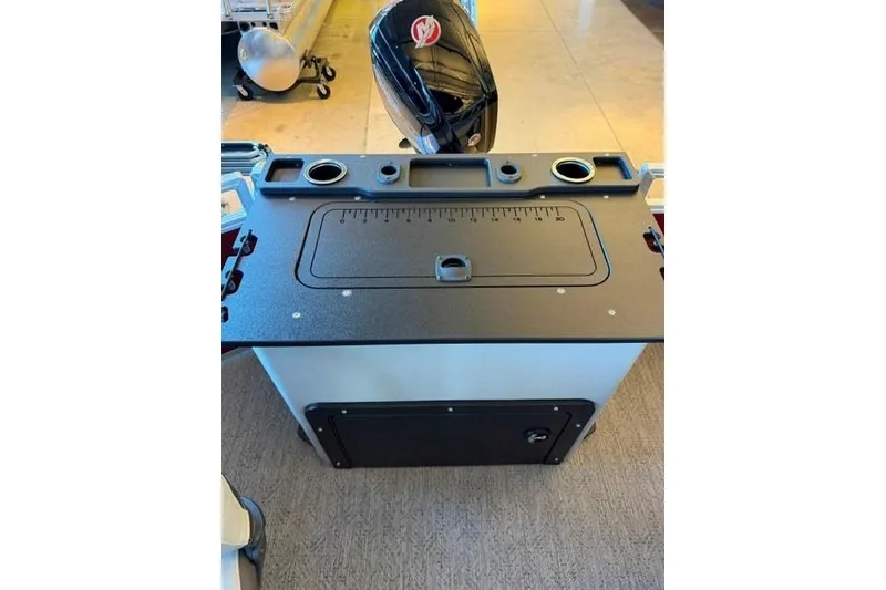 Slide: The Image of 2026 Sun Tracker Fishin' Barge 22 DLX console with storage and cup holders. - 7
