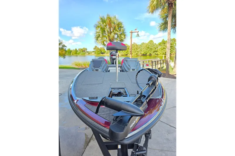 Slide: The Image of 2026 Nitro Z20 XL boat by a scenic lake with palm trees. - 9