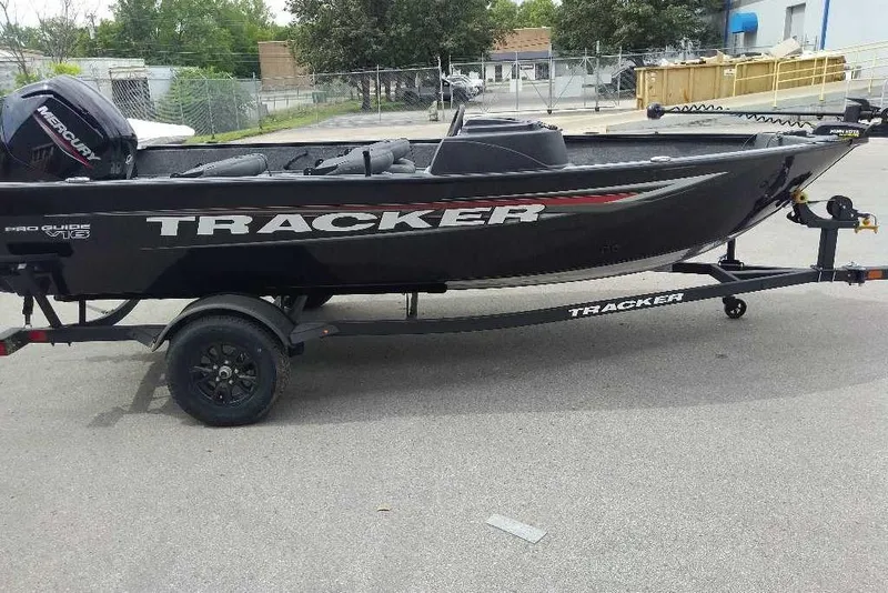 The Image of 2026 Tracker Pro Guide V-16 SC boat on trailer, parked outdoors. - 0
