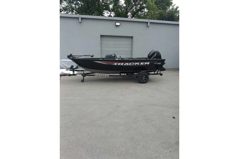 Slide: The Image of 2026 Tracker Pro Guide V-16 SC boat on trailer, parked outdoors. - 2