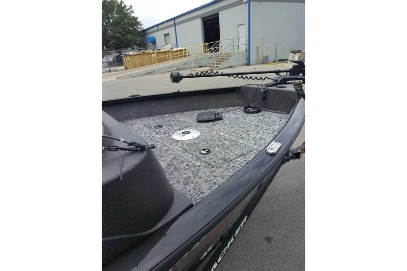 Slide: The Image of 2026 Tracker Pro Guide V-16 SC boat with carpeted deck and Minn Kota trolling motor. - 7