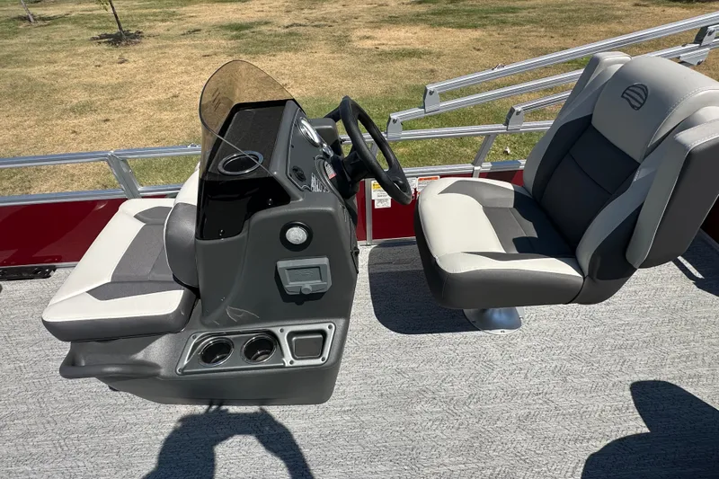 Slide: The Image of 2026 Sun Tracker Bass Buggy 18 DLX boat interior with steering console and seating. - 35