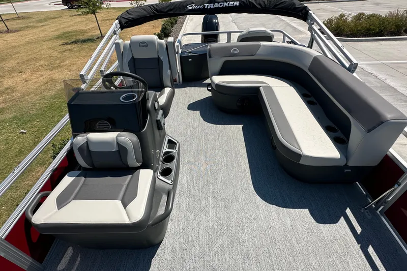Slide: The Image of 2026 Sun Tracker Bass Buggy 18 DLX pontoon boat interior with seating and helm. - 29