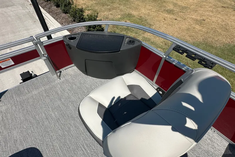 Slide: The Image of 2026 Sun Tracker Bass Buggy 18 DLX boat seat and console, featuring red accents. - 28